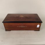 A late 19th Century lever wind musical box playing ten airs in an inlaid walnut case (comb and