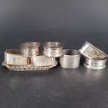 A small embossed silver pin tray and seven various silver napkin rings,