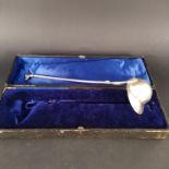 An unusual white metal punch ladle in the form of a jockey cap with riding crop form handle and