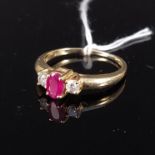 A 14ct gold ruby and diamond three stone ring, size P, weight approx 2.