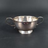 A silver two handled bowl on flared base, hallmarked Birmingham 1974, maker Barker Ellise Co.