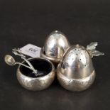 A Victorian silver condiment set of acorn form (as found) with one matching spoon, hallmarks rubbed,