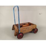 A vintage Triang baby walker with a wooden train set