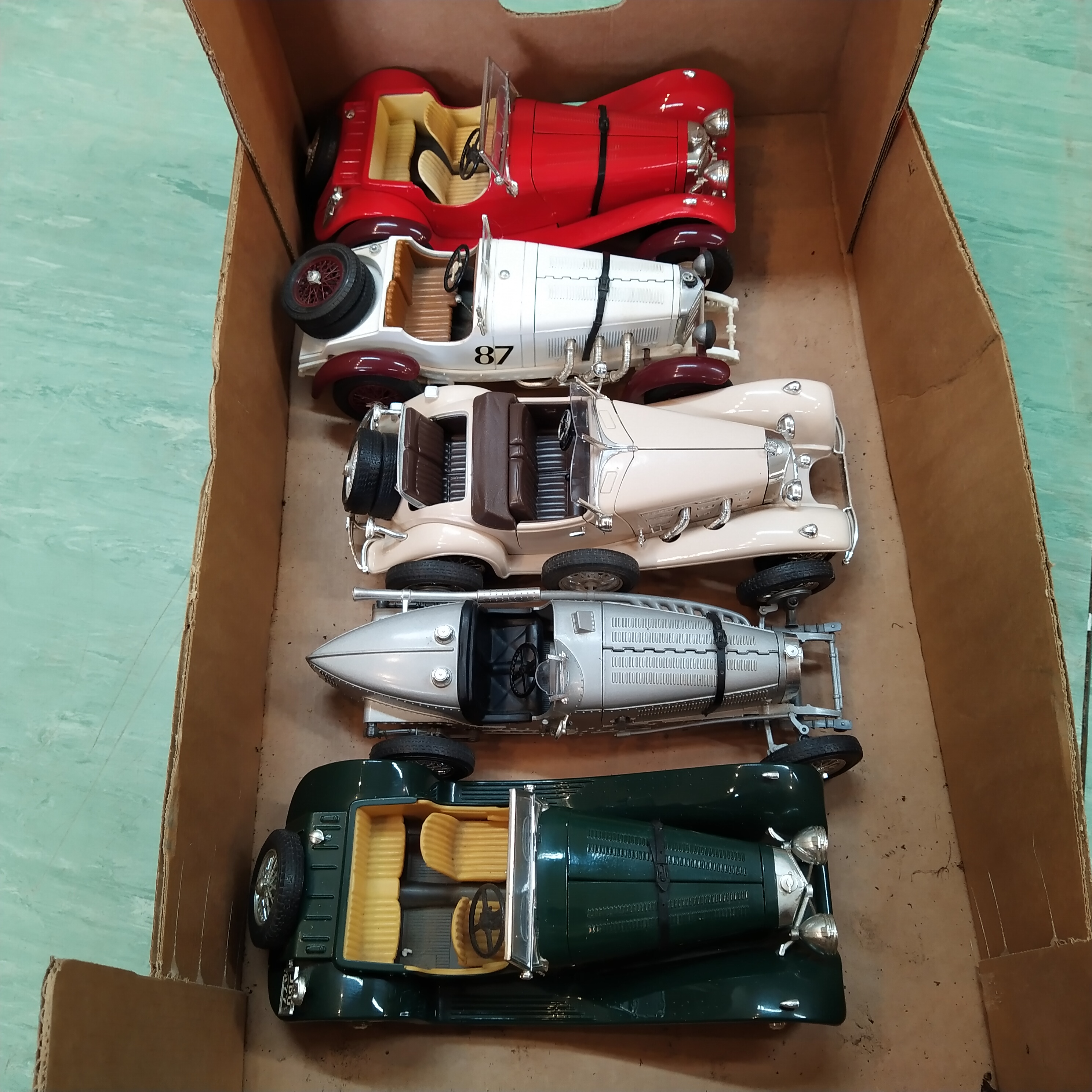 Nine Burago and Maisto 1:18 scale die cast cars plus a selection of display boxes