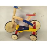 A wooden childs bike and a ride-a-long