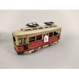 A tin plate vintage clockwork tram, marked 'SG' on doors,