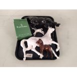 A Royal Doulton black finish rearing horse plus a white example,