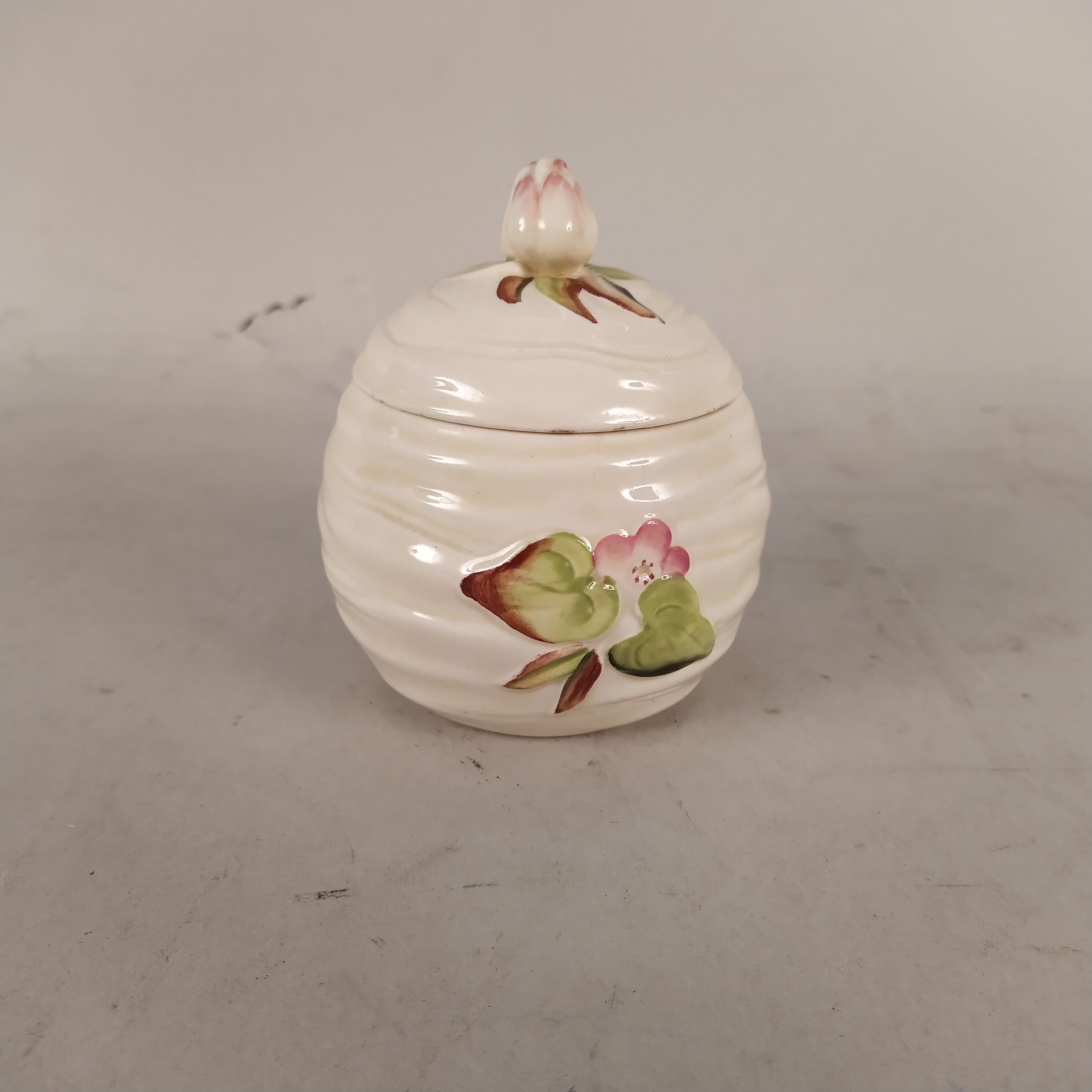 A Clarice Cliff Newport pottery shape 987 jam pot and lid