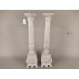 A pair of large white finish and distressed wood candle stands,