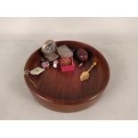 A wooden fruit bowl and contents including a desk calendar,