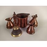 A small seamed copper pot, a graduated set of three copper jugs, a school bell,