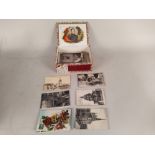 A selection of early 20th Century postcards in old cigar box plus an antique chestnut roaster and
