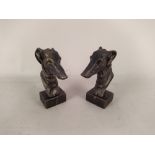 A pair of cast metal greyhound head door stops, a 19th Century oak framed print of Falmouth,