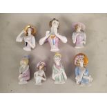 A collection of vintage early 20th Century porcelain pin cushion dolls,