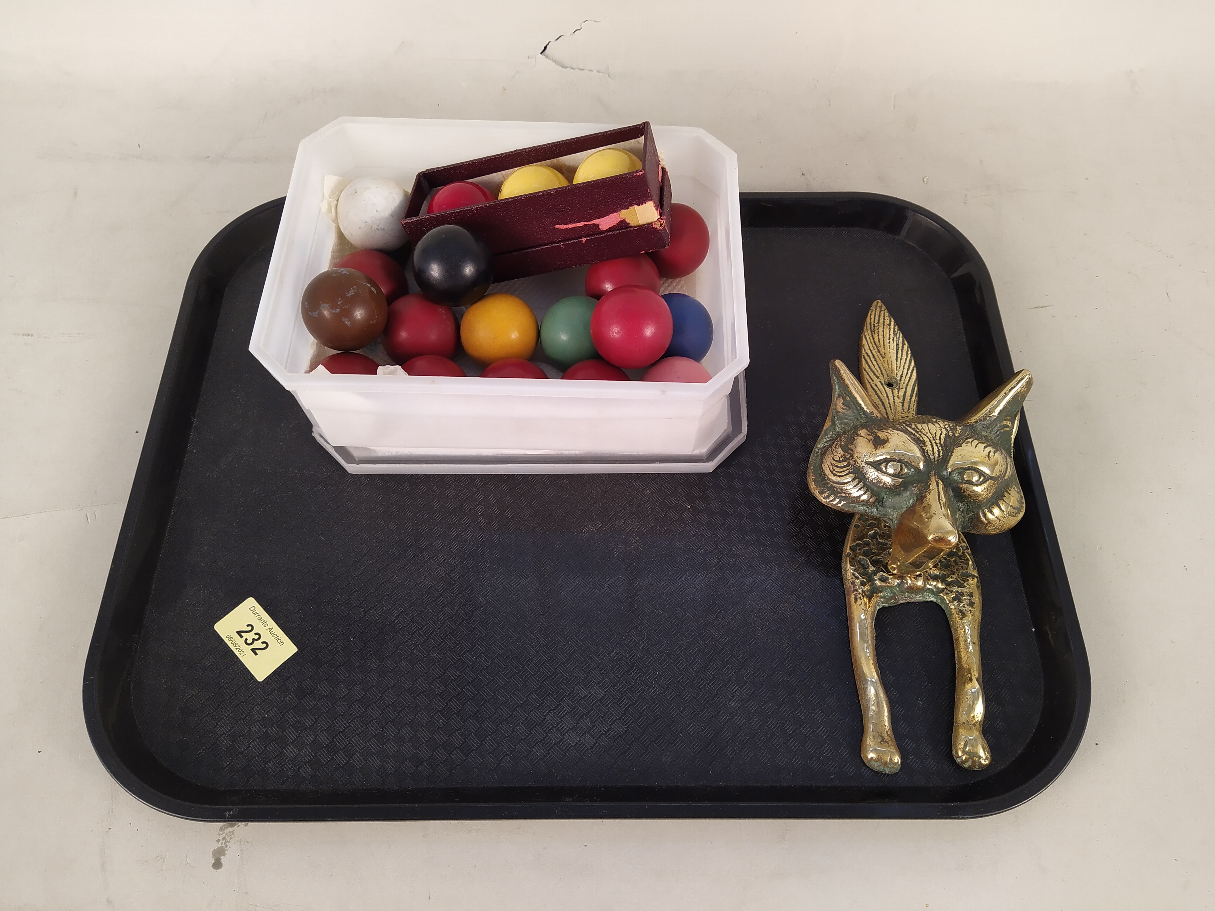 A vintage brass fox door knocker plus a set of half size snooker balls