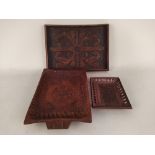 A selection of vintage carved wooden trays including a Trinidad nut tray