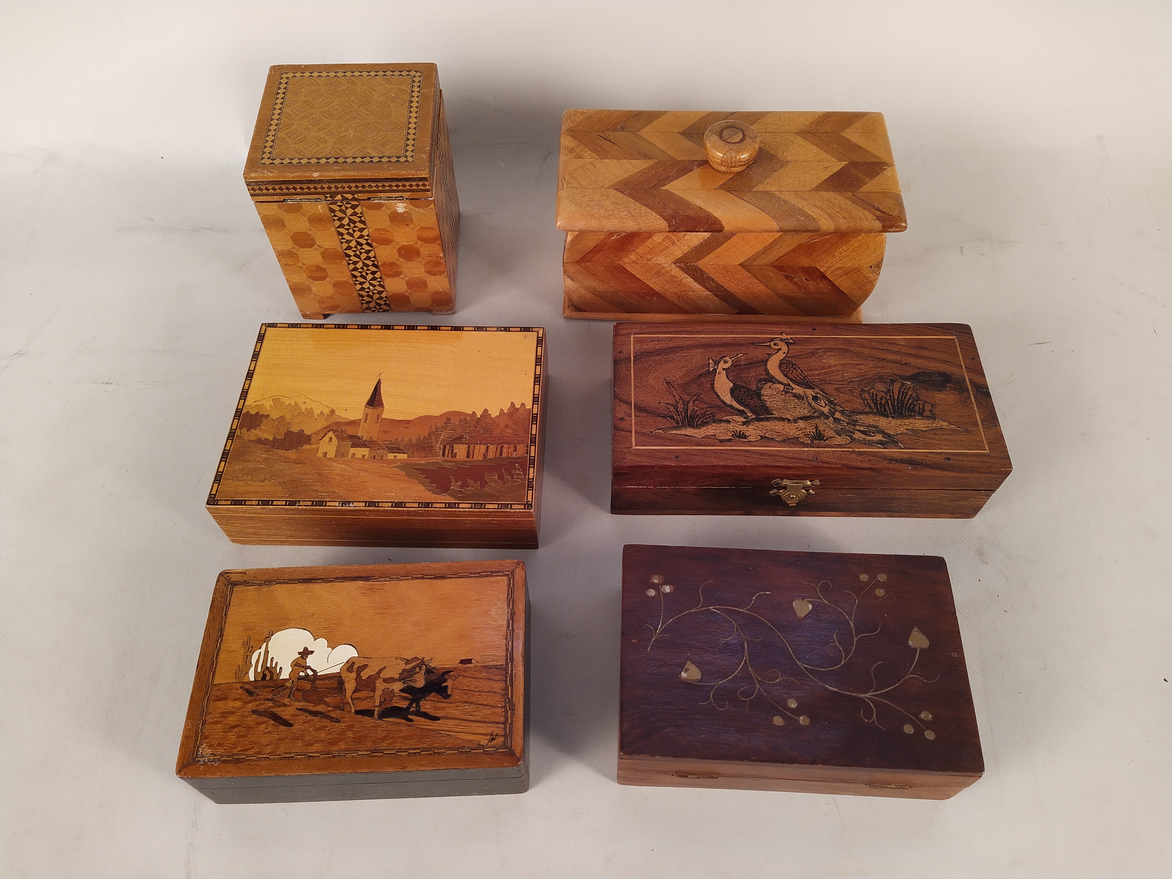 A large selection of inlaid wooden boxes,