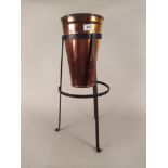 A late 19th Century copper conical water filter on wrought iron stand