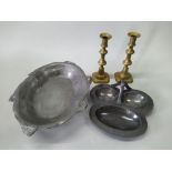 A box of mixed metalware including a pair of Victorian brass candlesticks, pewter dishes,