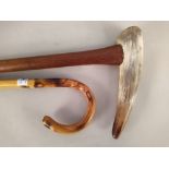 A long walking stick with horn tusk handle plus a shooting stick and one other cane