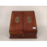 A late 19th Century oak stationery cabinet with fitted interior,