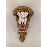 An ornate gilt wood corbel with resin cherubs,