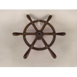 A small vintage brass and mahogany ships wheel
