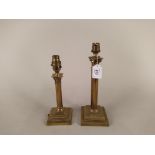Two early 20th Century Corinthian column brass table lamps on stepped square bases,
