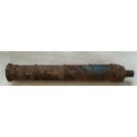A heavy cast iron Chinese cannon of considerable age with Chinese characters in relief with
