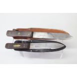 Two 'Green River' knives with leather sheaths,