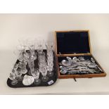 A tray of mixed glassware plus a wood cased part canteen of Ashberry cutlery