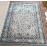 A wool carpet with central pattern of vases of flowers and a wide floral border in pink and blue on