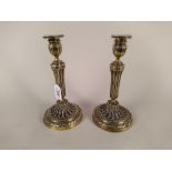 A pair of 18th Century French brass pillar candlesticks with fluted stems,