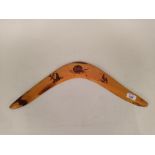 An aboriginal boomerang with pokerwork decoration,