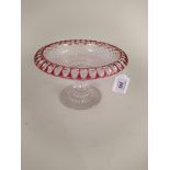 An early 20th Century clear glass with cranberry overlay on rim stemmed dish,