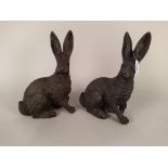 A pair of solid bronze hare figures,