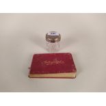 A vintage autograph book with various signatures plus a hallmarked silver lid dressing table jar