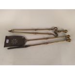 A heavy set of three 19th Century brass and iron fire irons with knopped shafts and pierced shovel,