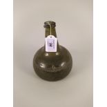 An 18th Century green glass onion shaped wine bottle,