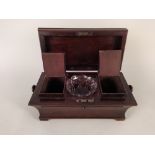 A mid Victorian rosewood tea caddy with fitted canisters to interior