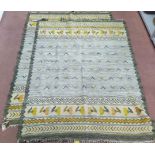 A pair of kilims on grey and beige ground with floral and geometric borders,