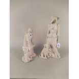 Two unglazed figures of ladies, one seated the other standing with dog, with pastel highlights,