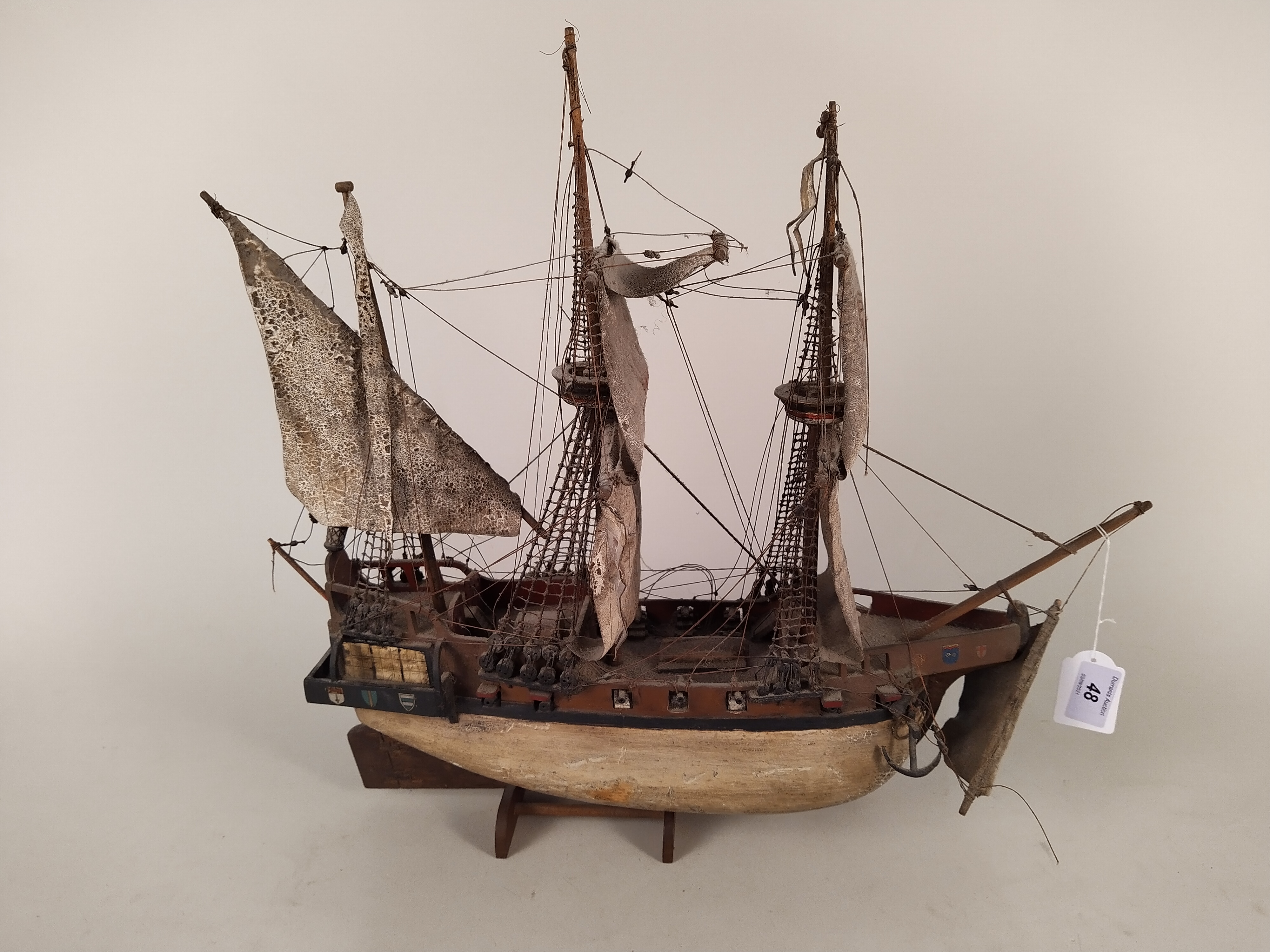 A model of a wooden hulled fully rigged Elizabethan galleon with painted sails