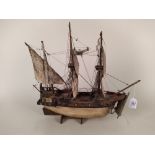 A model of a wooden hulled fully rigged Elizabethan galleon with painted sails