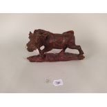 A vintage hand carved warthog, purchased in Africa with inset tusks,
