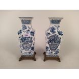 A pair of Chinese blue and white porcelain vases on fitted brass stands