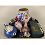 A tray of mixed items including a Chinese blue and white jar, a glass chicken,