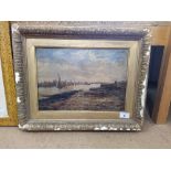 A late 19th Century oil on board of a river scene with forshore and sailing vessels (indistinctly