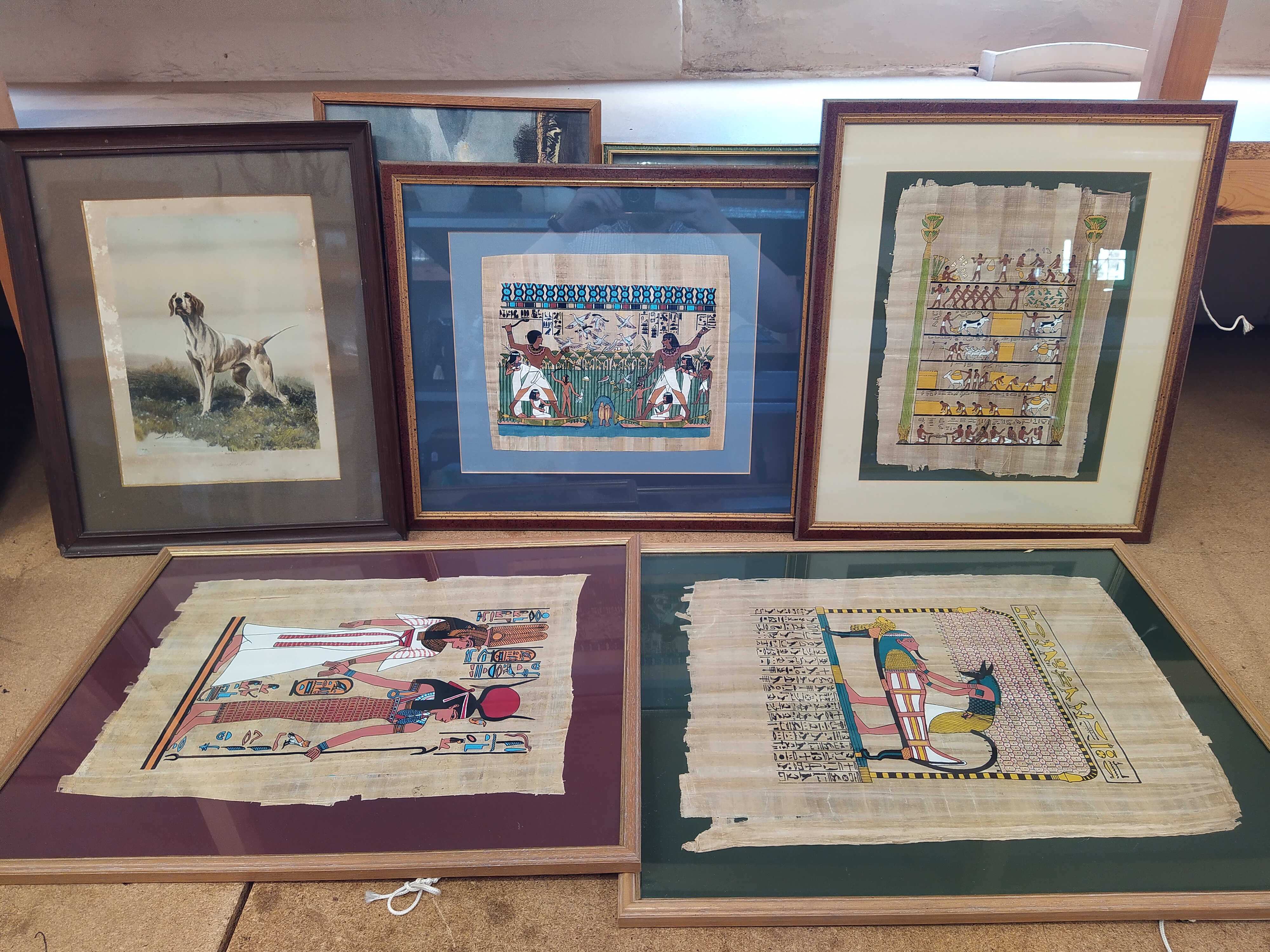 A box of mixed pictures including hand painted Egyptian on papyrus, Salvador Dali print,