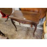 A Victorian carved walnut card table